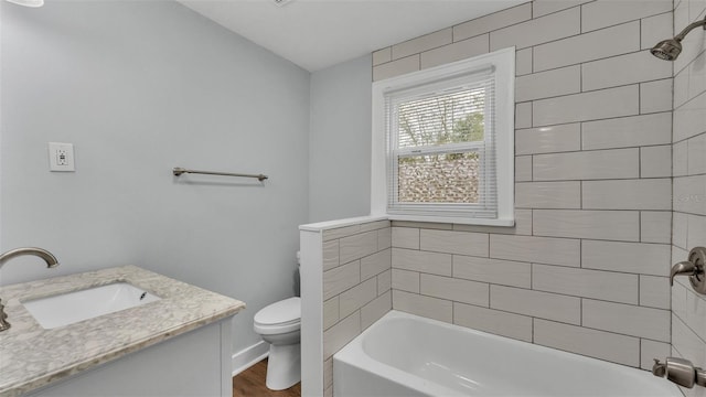 full bathroom featuring tiled shower / bath, vanity, toilet, and wood-type flooring