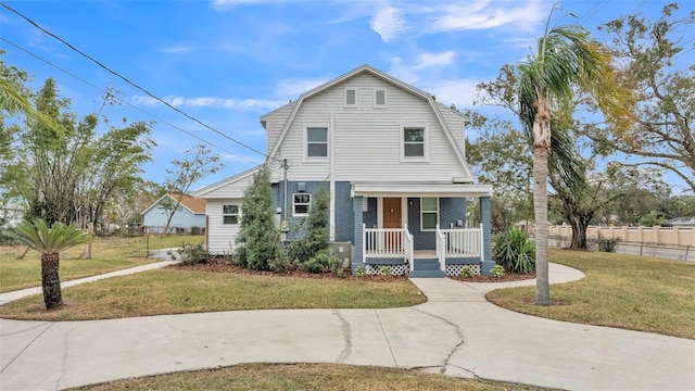 view of property with a porch and a front yard