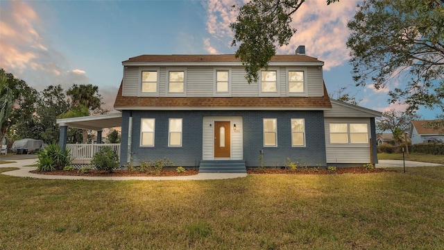 view of front of property featuring a yard and covered porch