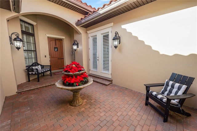 doorway to property featuring a patio and french doors