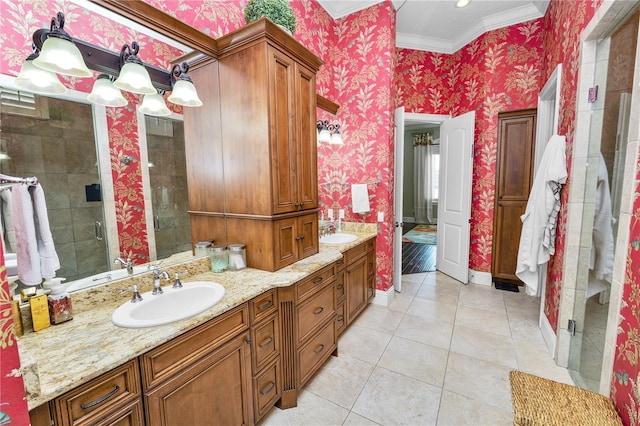 bathroom with crown molding, vanity, a shower with door, and tile patterned flooring