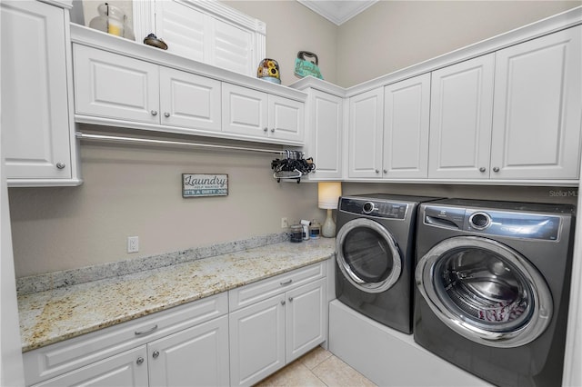 laundry room with cabinets, separate washer and dryer, and light tile patterned floors