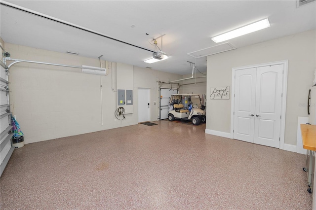 garage with a garage door opener and electric panel