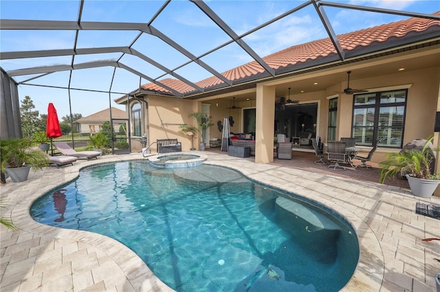 view of pool with a lanai, a patio area, ceiling fan, and an in ground hot tub