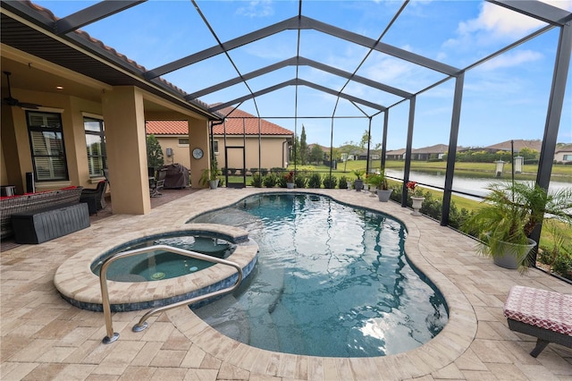 view of pool featuring an in ground hot tub, a water view, a patio area, and a lanai