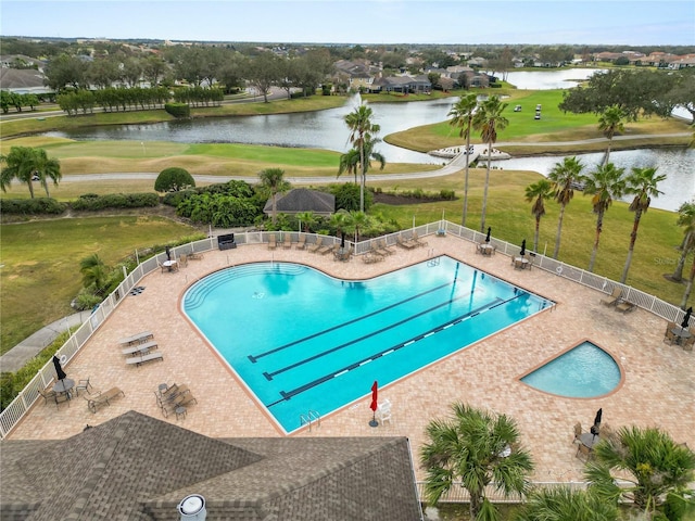 view of swimming pool with a water view, a yard, and a patio