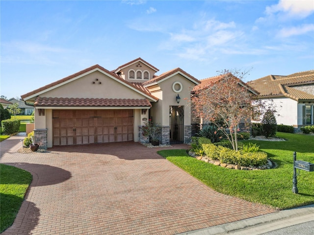 mediterranean / spanish home with a garage and a front yard