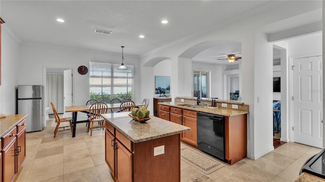 kitchen with sink, stainless steel refrigerator, dishwasher, a center island, and decorative light fixtures