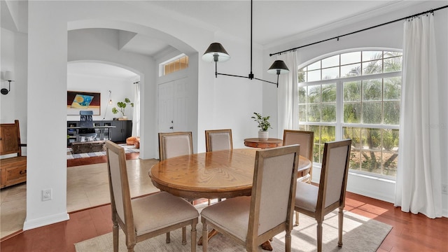 dining space with hardwood / wood-style flooring and ornamental molding