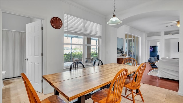 dining room with light tile patterned floors, crown molding, and ceiling fan