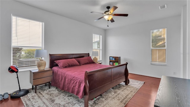 bedroom with hardwood / wood-style flooring and ceiling fan