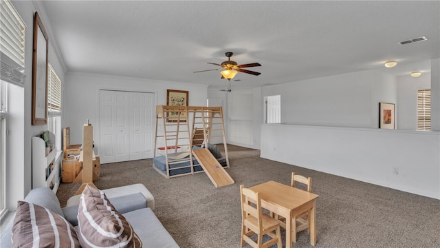 carpeted living room featuring ceiling fan