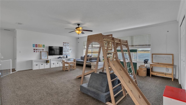 bedroom featuring ornamental molding, a textured ceiling, and dark carpet