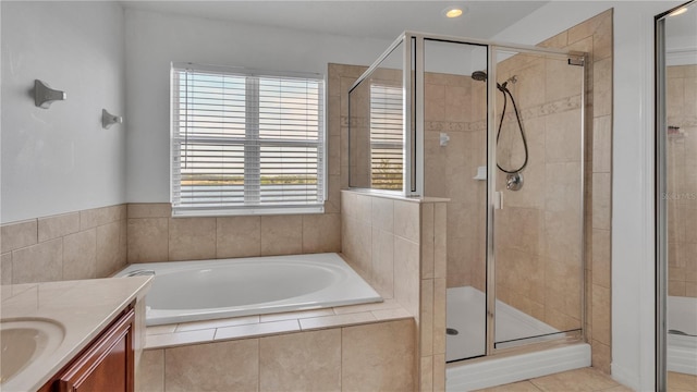 bathroom featuring vanity, tile patterned floors, and plus walk in shower