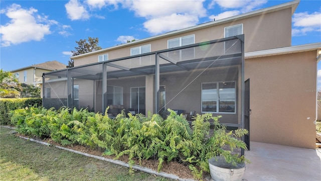 back of house with a lanai