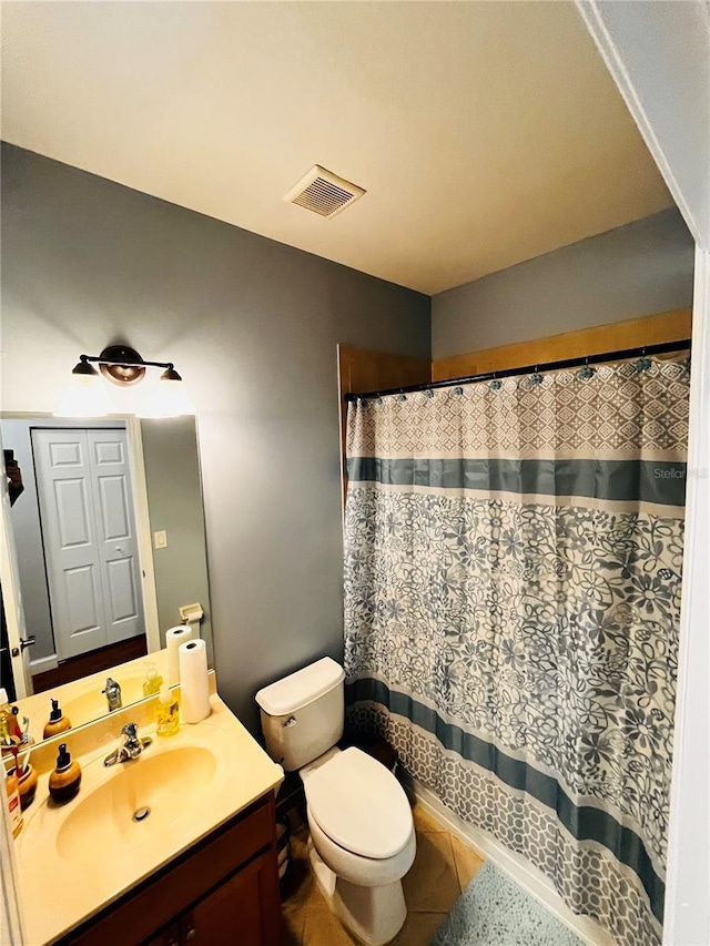 bathroom featuring vanity, tile patterned floors, and toilet