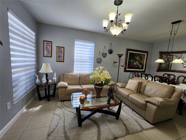 living area with light tile patterned flooring, baseboards, and an inviting chandelier