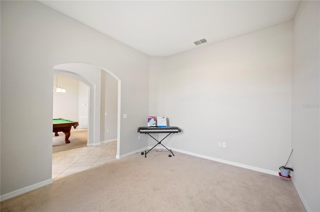 carpeted spare room featuring baseboards, billiards, visible vents, and arched walkways