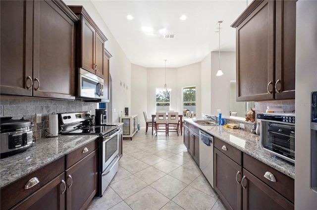 kitchen featuring stainless steel appliances, visible vents, and dark brown cabinets