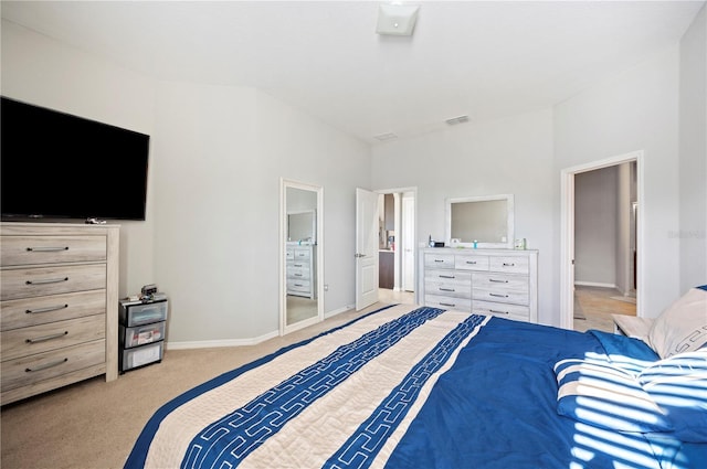 bedroom with baseboards, visible vents, and light colored carpet