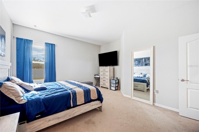 carpeted bedroom featuring baseboards