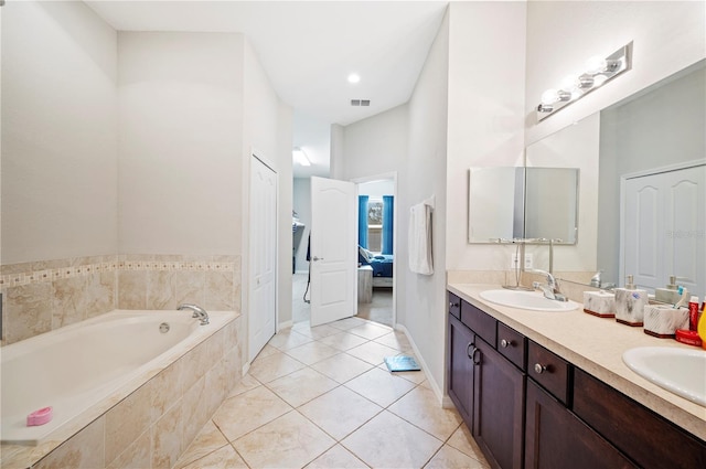 bathroom with double vanity, visible vents, ensuite bath, a garden tub, and a sink