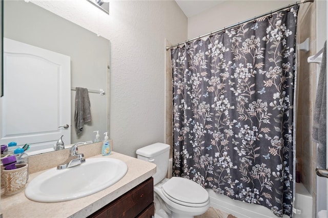 bathroom featuring shower / bathtub combination with curtain, a textured wall, vanity, and toilet