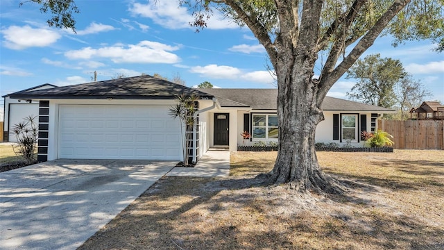 single story home with a garage and a front yard