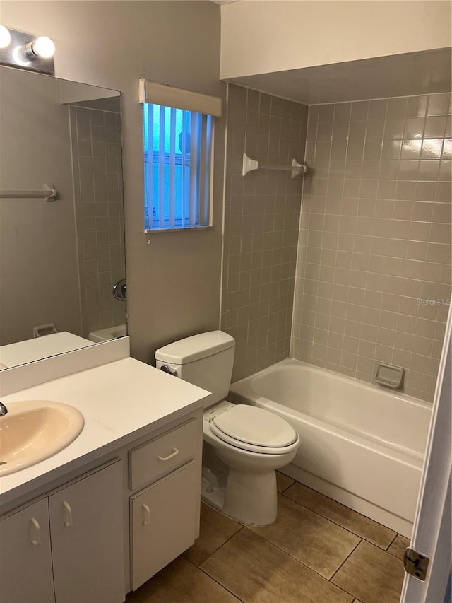 full bathroom with tile patterned flooring, vanity, toilet, and tiled shower / bath