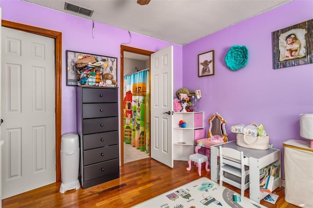 recreation room with hardwood / wood-style floors