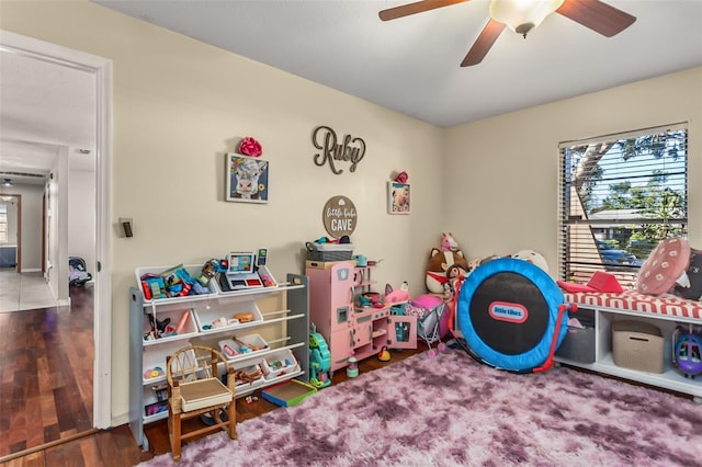 rec room with dark wood-type flooring and ceiling fan