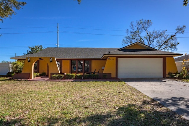 single story home with a garage and a front lawn