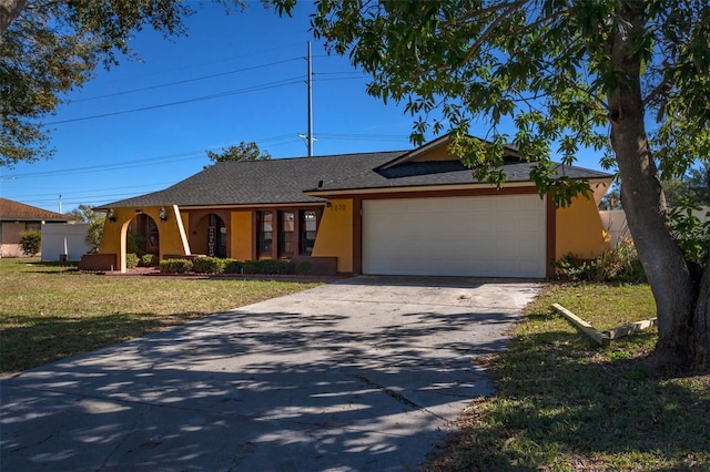 single story home with a garage and a front lawn