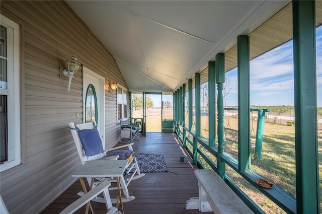 sunroom / solarium with plenty of natural light and vaulted ceiling