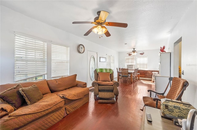 living room featuring ceiling fan, hardwood / wood-style floors, and a textured ceiling