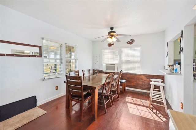 dining room featuring dark wood-type flooring, cooling unit, and ceiling fan