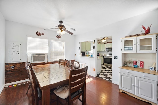 dining area featuring cooling unit, ceiling fan, and dark wood-type flooring