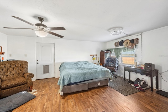 bedroom with hardwood / wood-style flooring and ceiling fan