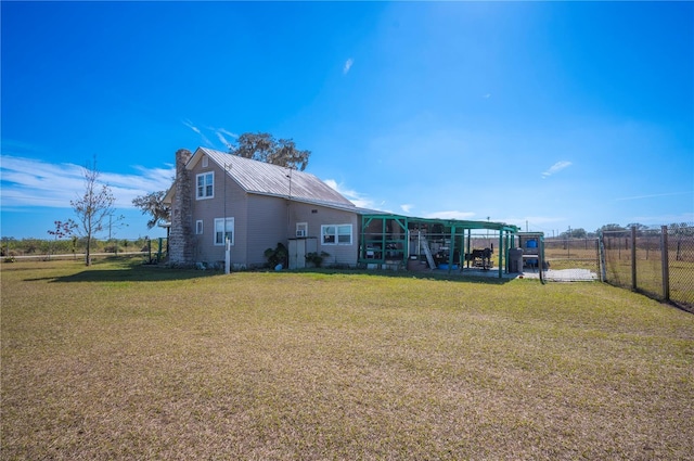 back of house with a lawn