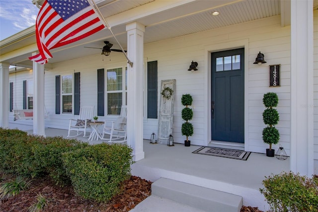 entrance to property with ceiling fan and covered porch