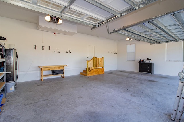 garage featuring a garage door opener and stainless steel fridge