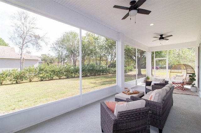 sunroom / solarium with a wealth of natural light and ceiling fan