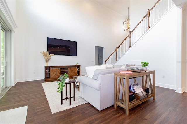 living room featuring dark hardwood / wood-style floors and a high ceiling