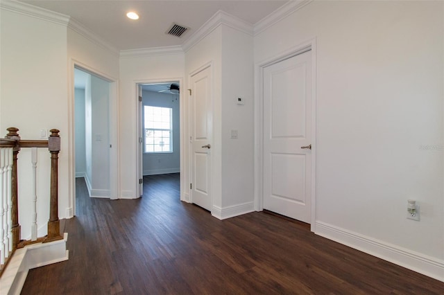 hall featuring ornamental molding and dark hardwood / wood-style flooring