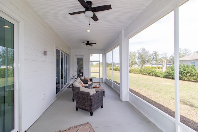 sunroom featuring ceiling fan