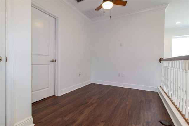 spare room with crown molding, dark wood-type flooring, and ceiling fan