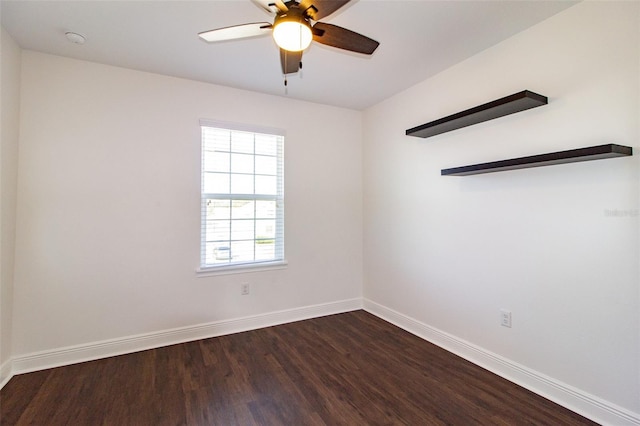 unfurnished room featuring dark wood-type flooring and ceiling fan