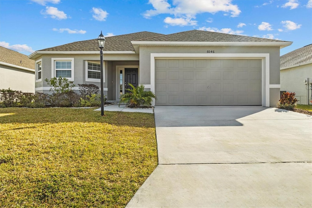 view of front of home with a garage and a front yard