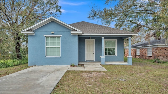 view of front of home with covered porch and a front yard