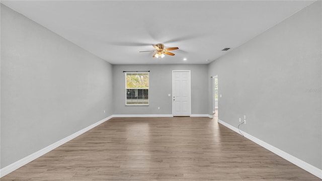 empty room with ceiling fan and light wood-type flooring